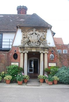 an old building with potted plants in front of it