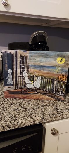 two paintings sitting on top of a kitchen counter