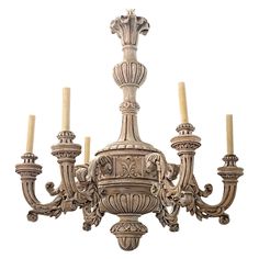 an ornate chandelier with five candles on each arm and four lights in the middle