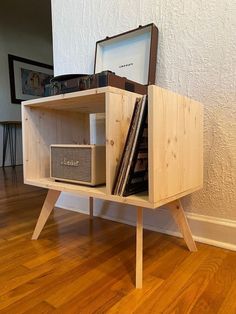 a wooden shelf with books and speakers on it