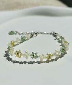 Free shipping for orders over $35 Handcrafted floral bracelet featuring exquisite jade-like and pearl like beads. Long Bead Bracelet, Cheap Elegant Flower Shaped Beaded Bracelets, Delicate Green Adjustable Beaded Bracelets, Green Beaded Pearl Bracelets, Green Beaded Flower Crystal Bracelet, Dainty Flower Pearl Beaded Bracelets, Delicate Handmade Green Bracelet, Dainty Adjustable Green Pearl Bracelet, Green Pearl Beaded Bracelets As Gift