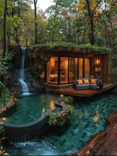 a house in the woods with a pool and waterfall