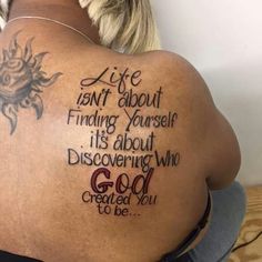 the back of a woman's body with tattoos on it and words written in cursive writing