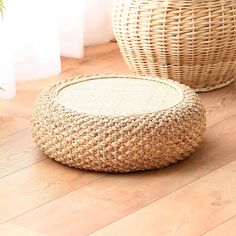 two wicker baskets sitting on the floor next to each other