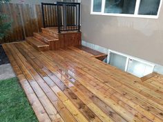 a wooden deck in front of a house