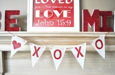 a valentine's day mantle decorated with red and white letters