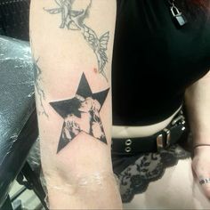 a woman with a star tattoo on her arm