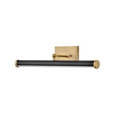 a black and gold toilet paper holder on a white wall with a light fixture in the middle