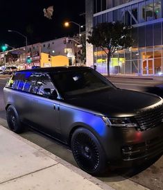 a black range rover parked on the side of the road