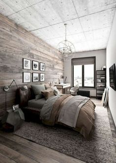 a bedroom with wood paneling and pictures on the wall above the bed, along with an area rug