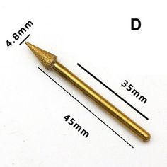 a gold colored metal tip with measurements