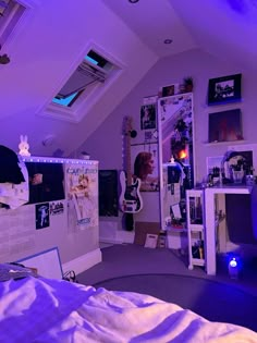 a bedroom with purple lighting and pictures on the wall