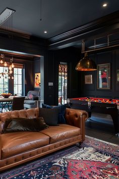 a living room filled with furniture and a pool table