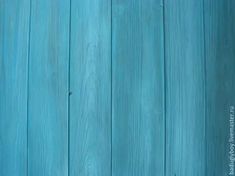 a blue wooden wall with some paint on it