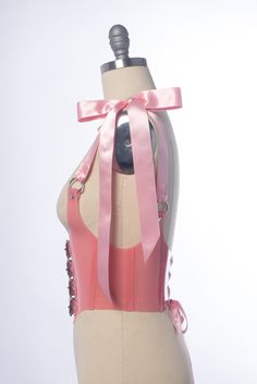 The pastel version of the Antoinette Buckle Harness Bodice is inspired both by 90s goth and Rococo stays. Four straps buckle in front just underneath the bust/chest. Double faced wide satin ribbon shoulder straps tie at the shoulders into bows. This is machine stitched with matching heavy duty thread. Laces up the back with grommets more satin ribbon. Available in pastel blush pink or light purple PVC. This material is slightly translucent. Silver-toned nickel plated steel hardware. Shown with m Pink Corset For Cosplay, Rococo Stays, Pink Rococo, Purple Pvc, Buckle Corset, 90s Goth, Pink Corset, Rococo, Satin Ribbon