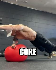 a man doing push ups on a red ball with the words core above his head