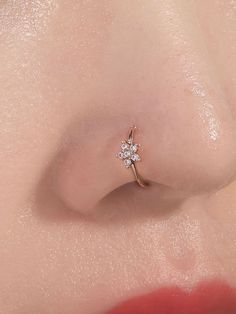 a woman's nose with a single diamond in the middle