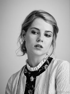 a black and white photo of a woman wearing a neck tie with flowers on it