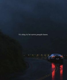 a car driving down a wet road at night with the words it's okay to let some people leave