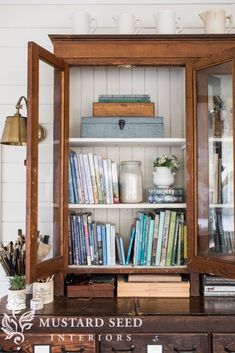 an old wooden bookcase with many books in it