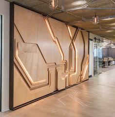 an office building with a large wooden wall that has neon lights on the side of it