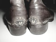 black and white photograph of shoes with hearts on them