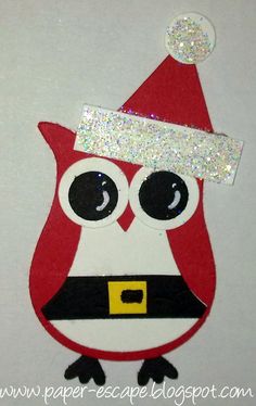 a red and white owl with a santa hat on it's head is shown