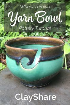 a green bowl sitting on top of a rock next to some trees and bushes with the words wheel thrown yarn bowl pottery tutor