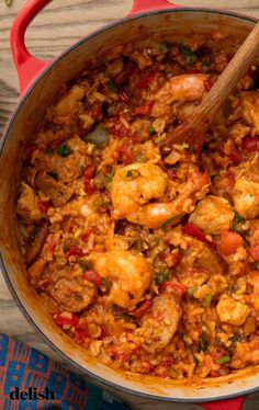 a red pot filled with shrimp and rice