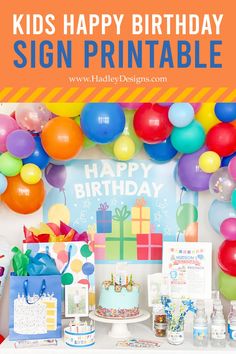 a birthday party with balloons and presents on the table, in front of a sign that says happy poster board