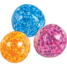 three different colored balls with speckles on the top one is orange, one is pink and one is blue