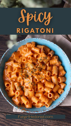 a blue bowl filled with pasta on top of a wooden table