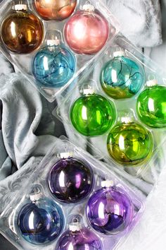 there are many different colored ornaments in the package