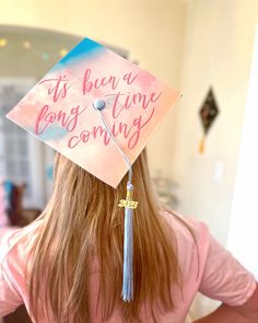 a woman wearing a graduation cap with the words it's been a long time coming