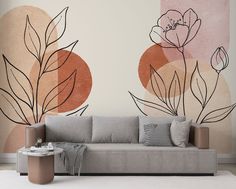 a living room scene with a couch and wall mural