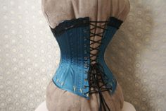 *THIS IS A MADE-TO-ORDER ITEM.* It's usually about 4-6 months between when you order your corset and when it arrives on your doorstep. Selecting faster shipping services will not make me sew any quicker, sorry This corset does NOT come with the muslin prototype step, like my other corsets. You get to choose the colors, but all other details are fixed. (you could also opt-out of the lace and/or embroidery if you wanted.) This corset is a medium weight late-Victorian corset, made with 1 layer of c Pretty Housemaid Corset, 1860s Corset, Cluny Lace, Hard Working Women, Victorian Corset, Dmc Embroidery Floss, Working Woman, Women's Costumes, Corsets