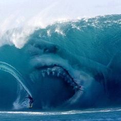 a man on a surfboard riding a huge wave with a shark's mouth