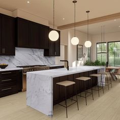 a large kitchen with marble counter tops and black cabinets