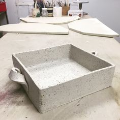 a white tray sitting on top of a counter next to a knife holder and other items