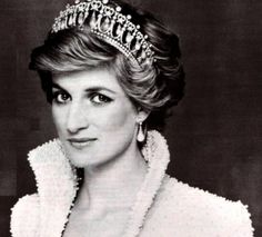 an old black and white photo of a woman wearing a tiara