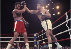 two men standing next to each other in a boxing ring