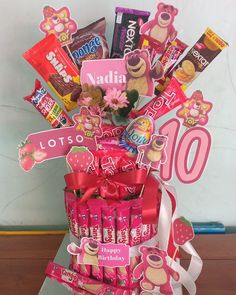 a pink basket filled with lots of candy and candies