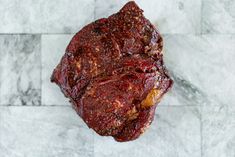 a piece of meat sitting on top of a marble counter