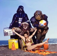 three people dressed as star wars characters on the beach