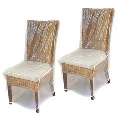 two wicker chairs covered in plastic sitting side by side on top of each other