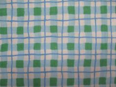 a blue and green checkered fabric with small squares on it's side,