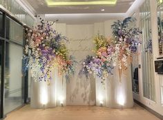 an entrance decorated with flowers and greenery