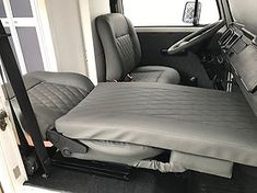 the interior of a vehicle with two seats on each side and one in the back