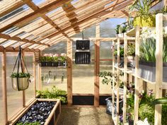 a greenhouse filled with lots of plants and potted plants