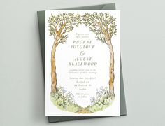 a wedding card with an illustration of two trees on the front and bottom, in watercolor